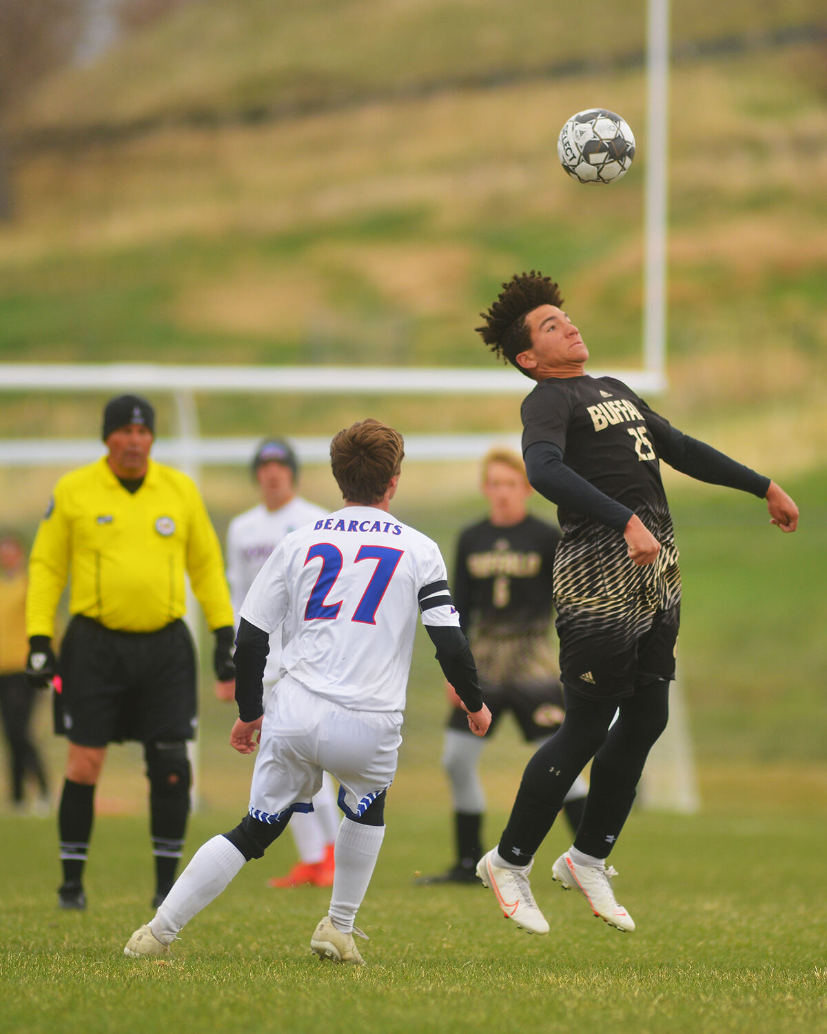 Kadon Boyce jumps to head the ball over the head